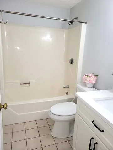 a bathroom with a shower a toilet and a shower