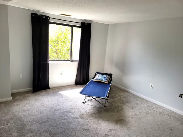 a view of room with a window and a chair
