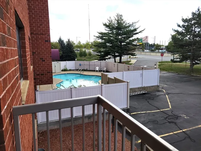 a view of a balcony with two chairs and a table