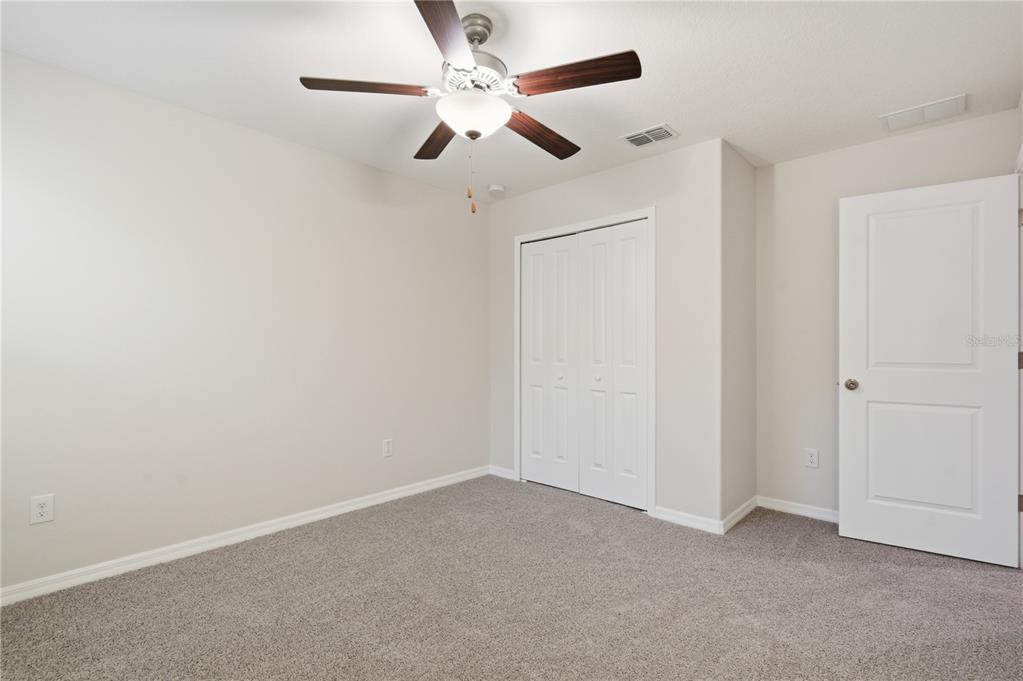 5223 Dandelion Street Apollo Beach, FL 33572 - Photo 13 of 19 an empty room with a ceiling fan and a fan