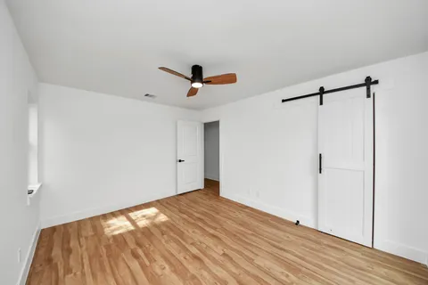 a bedroom with a bed and a large mirror