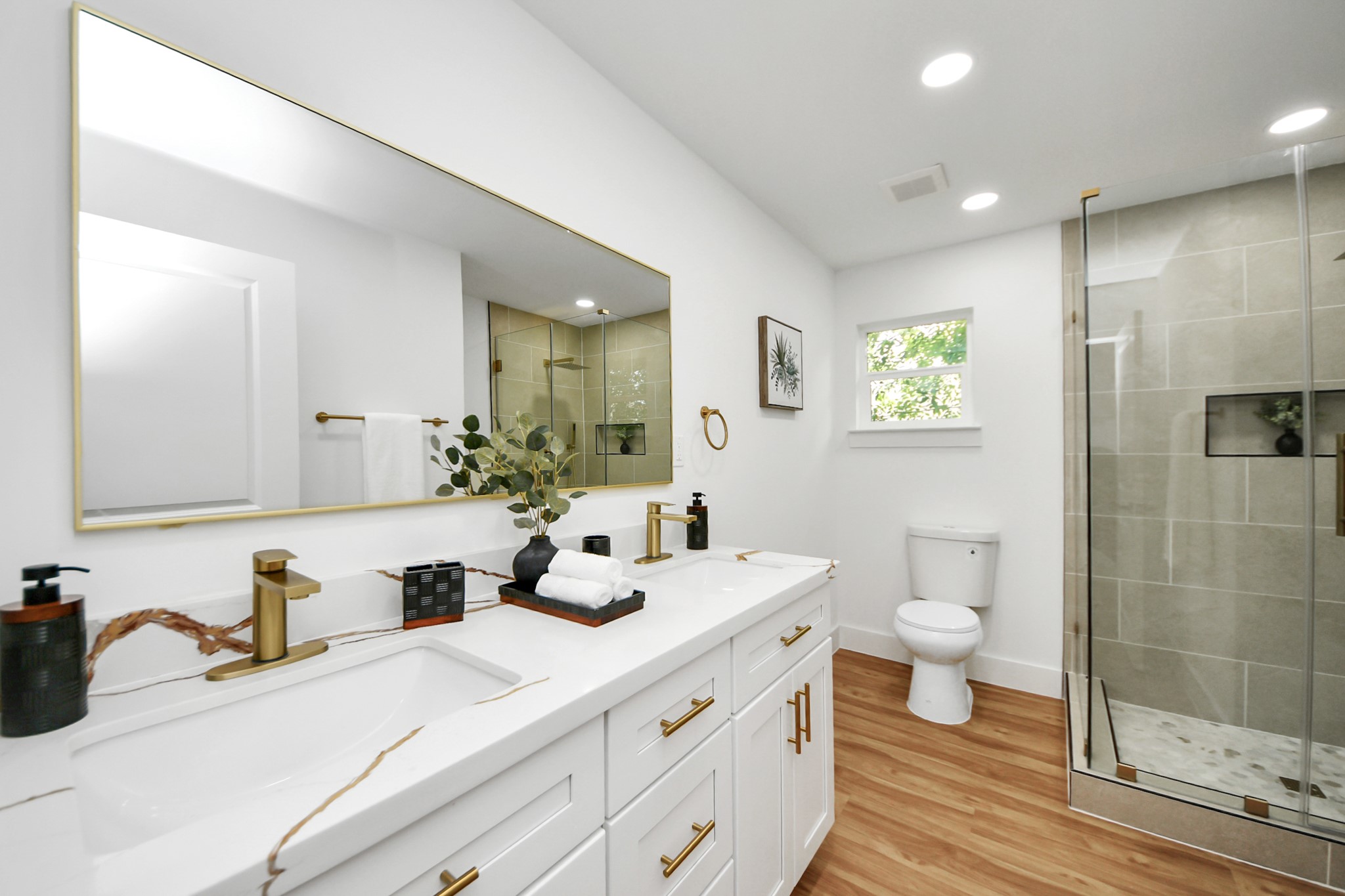 6249 Locke Lane Houston, TX 77057 - Photo 33 of 47 a bathroom with a sink double vanity and a toilet