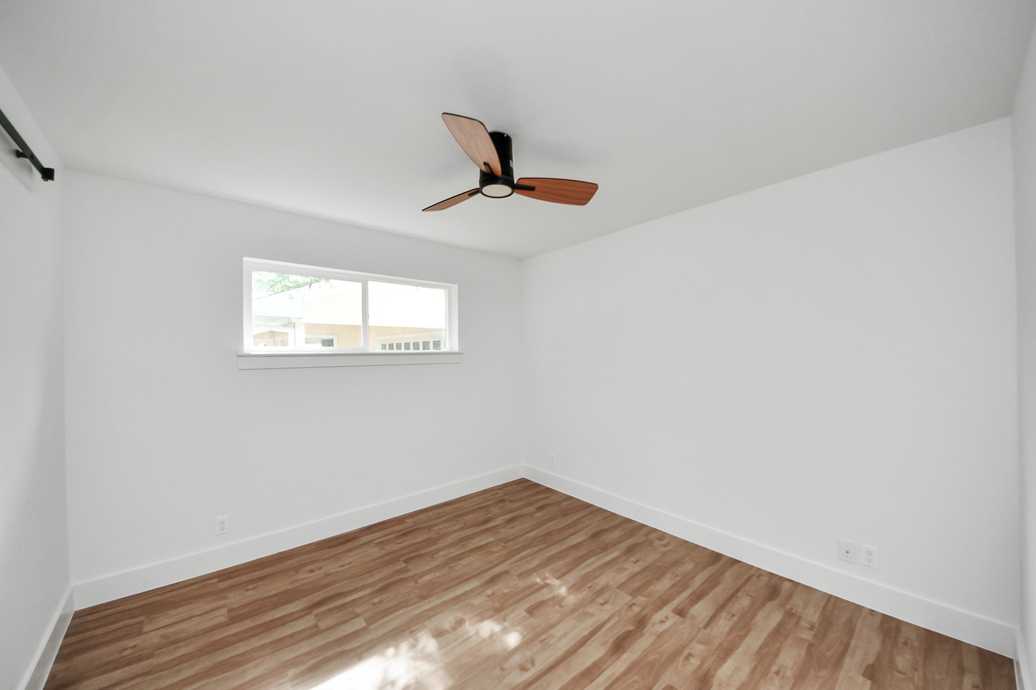 6249 Locke Lane Houston, TX 77057 - Photo 37 of 47 a view of a room with wooden floor and a ceiling fan