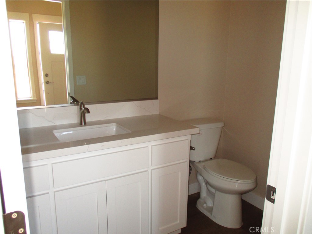 24236 Cahuilla Road Apple Valley, CA 92307 - Photo 16 of 48 a bathroom with a toilet sink and mirror