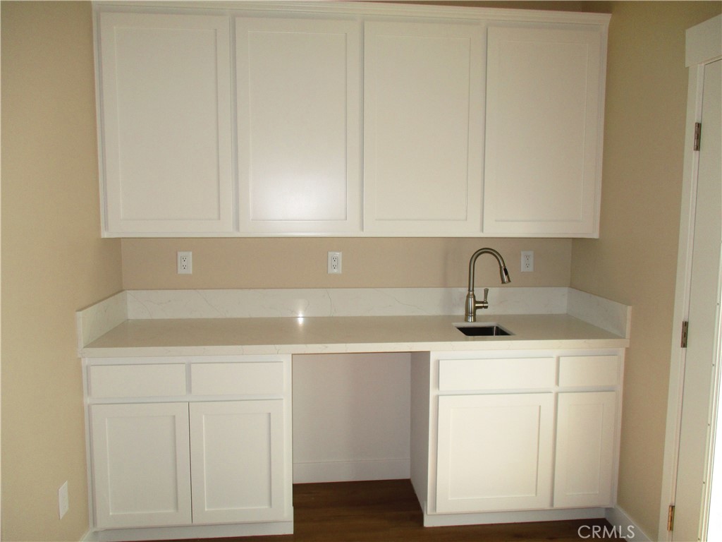 24236 Cahuilla Road Apple Valley, CA 92307 - Photo 21 of 48 a kitchen with a sink cabinets and utility