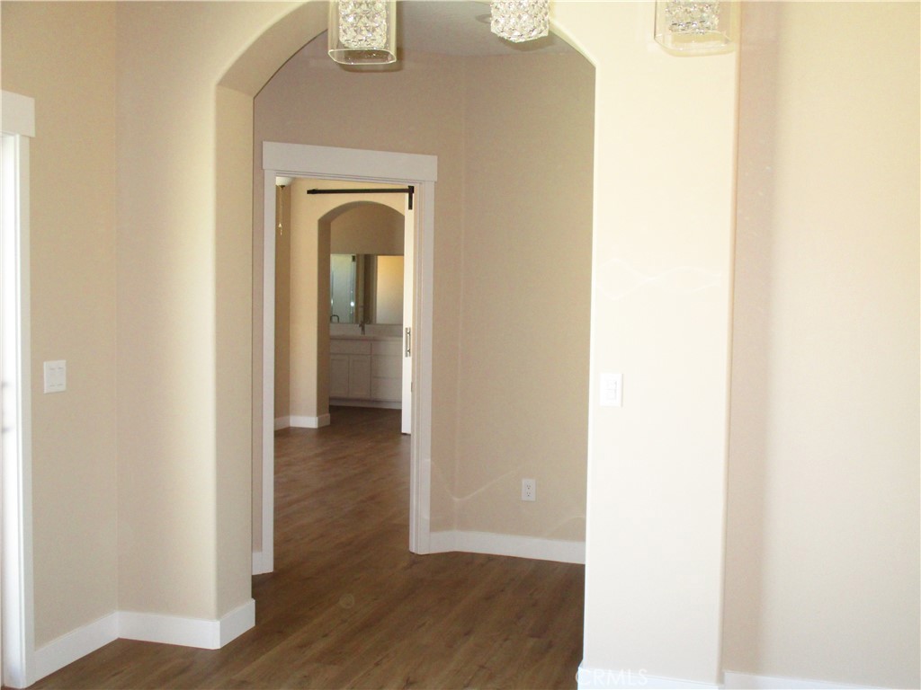 24236 Cahuilla Road Apple Valley, CA 92307 - Photo 27 of 48 a view of a hallway with wooden floor