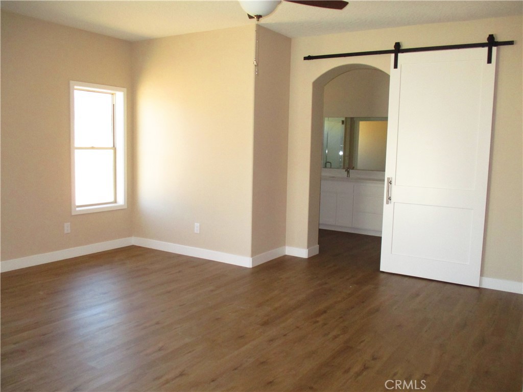 24236 Cahuilla Road Apple Valley, CA 92307 - Photo 28 of 48 a view of a room with wooden floor and a window