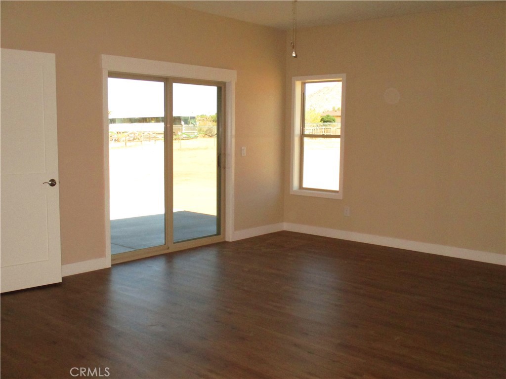 24236 Cahuilla Road Apple Valley, CA 92307 - Photo 30 of 48 an empty room with wooden floor and windows