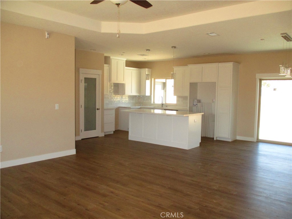 24236 Cahuilla Road Apple Valley, CA 92307 - Photo 8 of 48 a view of a kitchen with wooden floor