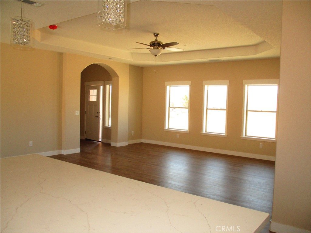 24236 Cahuilla Road Apple Valley, CA 92307 - Photo 9 of 48 wooden floor in an empty room with a window