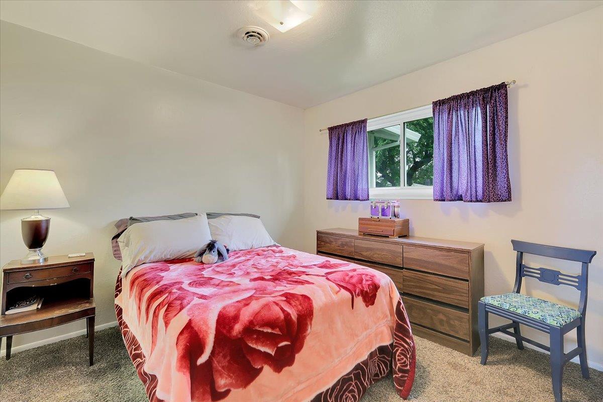 1650 North Township Road Yuba City, CA 95993 - Photo 13 of 27 a bedroom with a bed and a chair