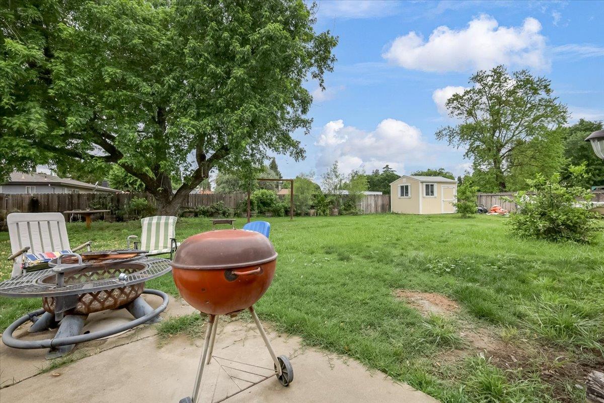1650 North Township Road Yuba City, CA 95993 - Photo 21 of 27 a view of a backyard with table and chairs potted plants and large tree