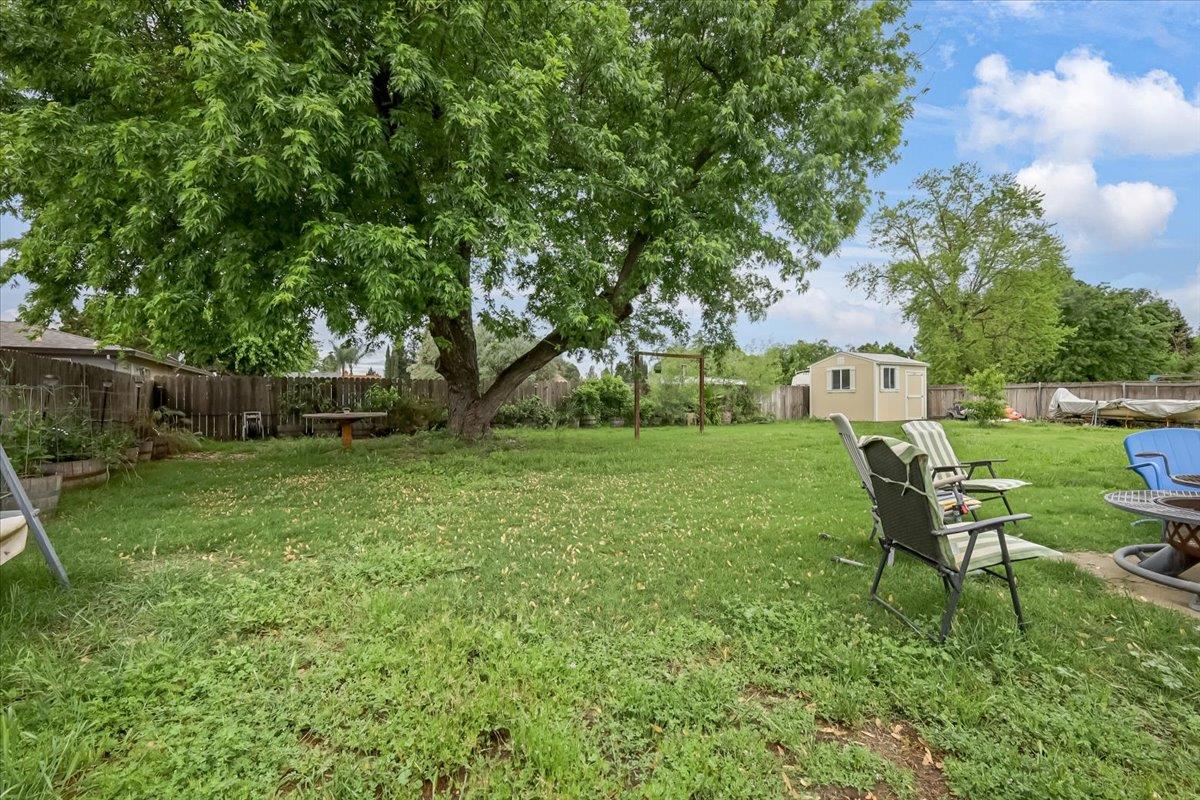 1650 North Township Road Yuba City, CA 95993 - Photo 22 of 27 a view of a backyard with table and chairs and a tree