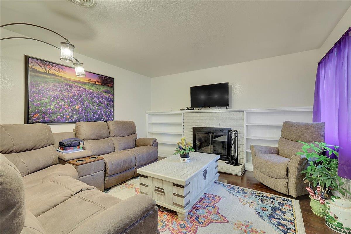 1650 North Township Road Yuba City, CA 95993 - Photo 10 of 27 a living room with furniture a fireplace and a flat screen tv