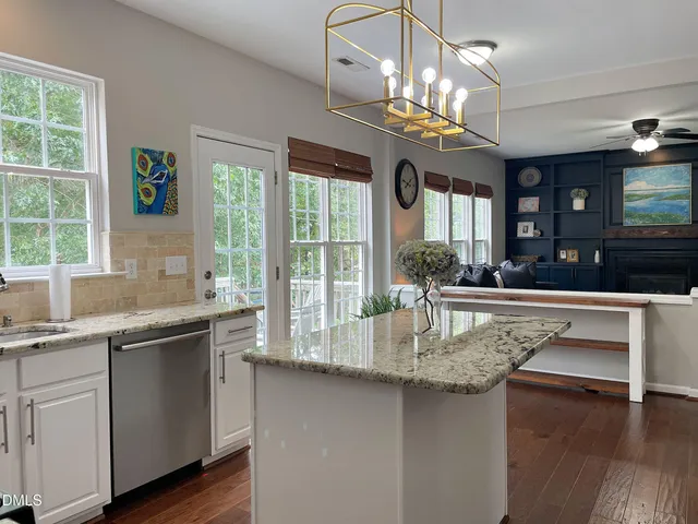 a kitchen with center island and windows