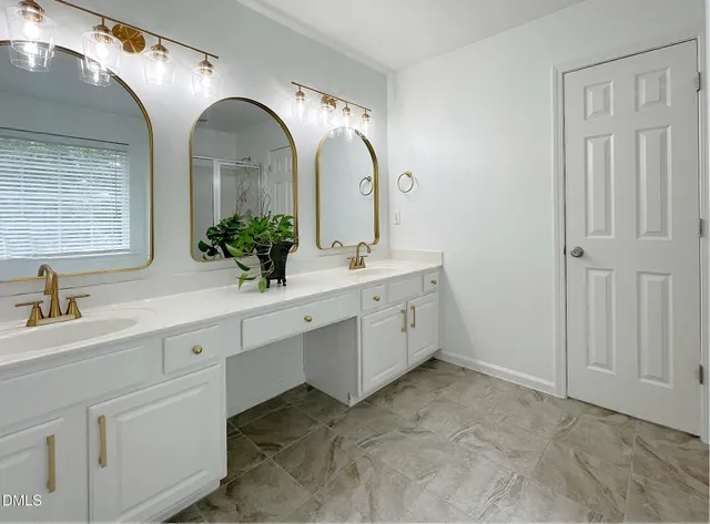 a bathroom with a double vanity sink and mirror