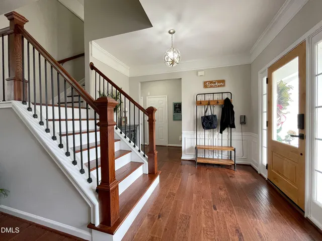 a view of entryway with wooden floor and stairs