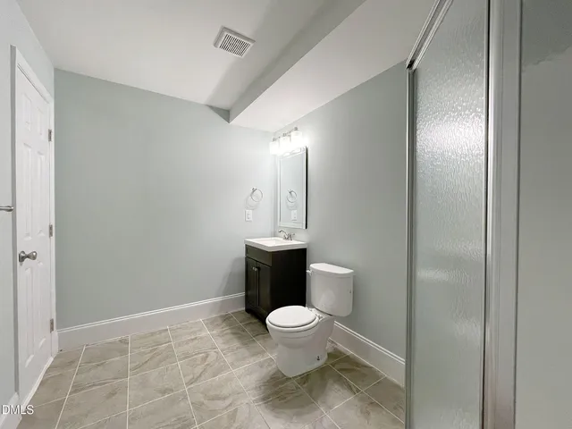 a bathroom with a toilet and a shower