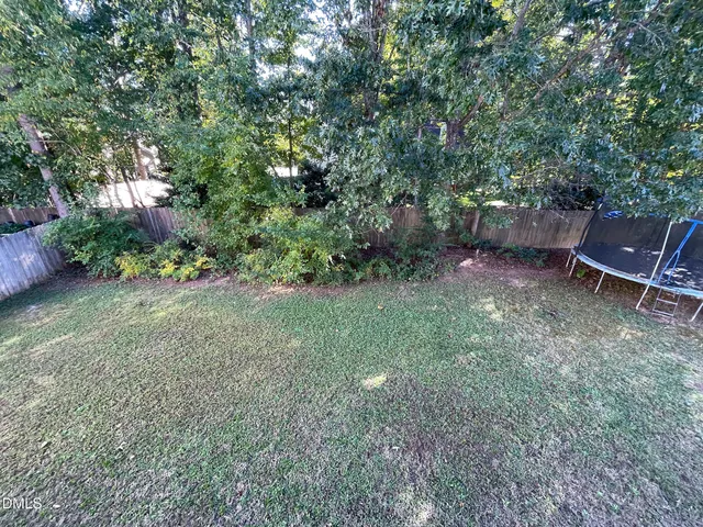 a view of a backyard with chairs and a table