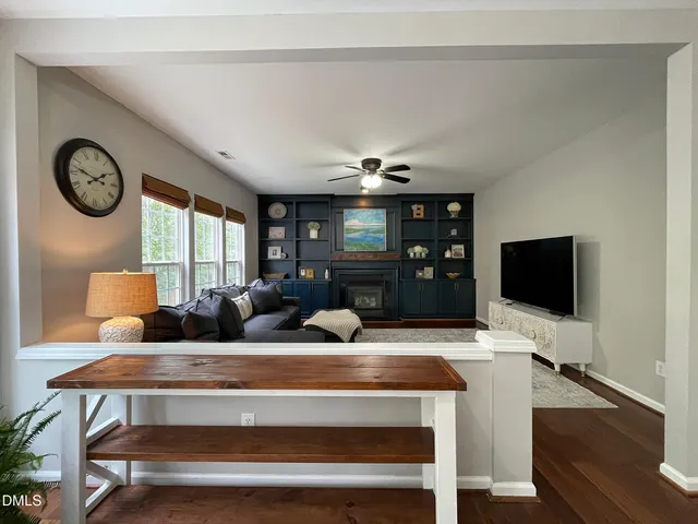 a living room with furniture a large window and a flat screen tv