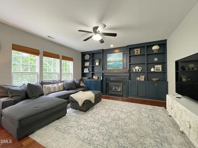 a living room with furniture window and flat screen tv