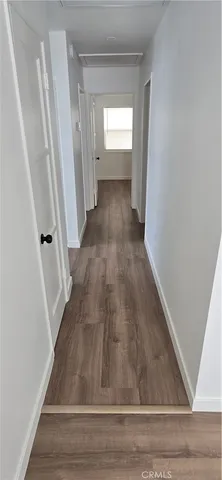 a view of a hallway view with wooden floor and staircase