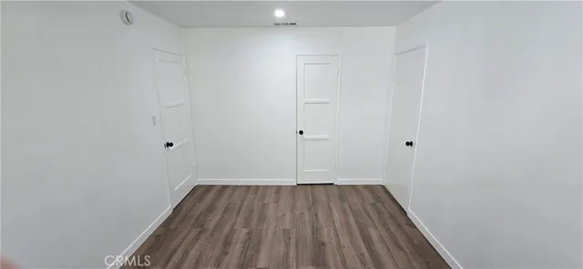 a view of a room with wooden floor