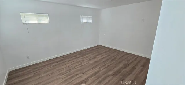 a view of room with wooden floor and fan