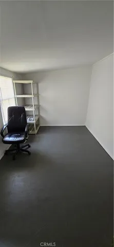 a view of a brick house with a small yard and plants