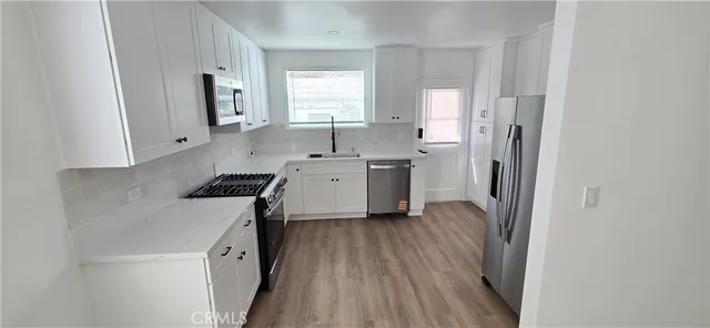 a kitchen with a sink stove and refrigerator