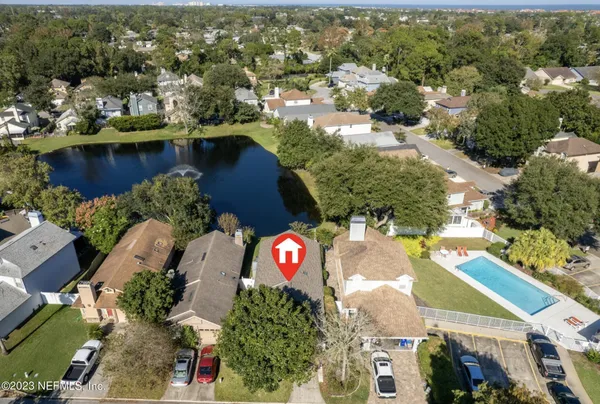 an aerial view of a house with a yard