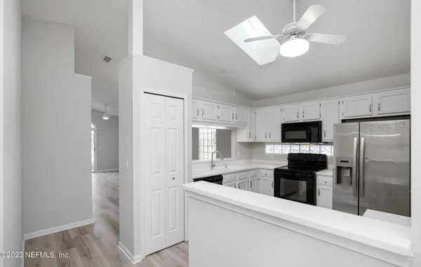 a kitchen with a refrigerator stove and microwave