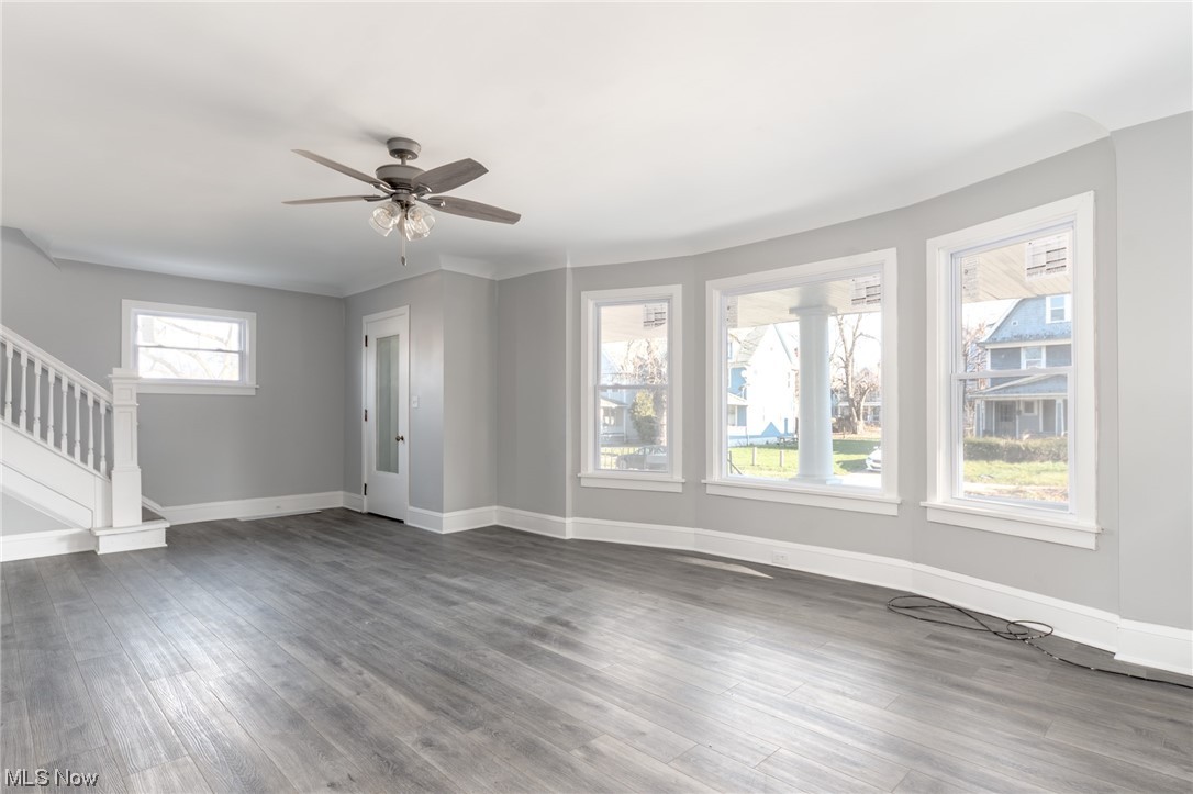 1228 Melbourne Road Cleveland, OH 44112 - Photo 5 of 35 Unfurnished living room with dark hardwood / wood-style floors and ceiling fan