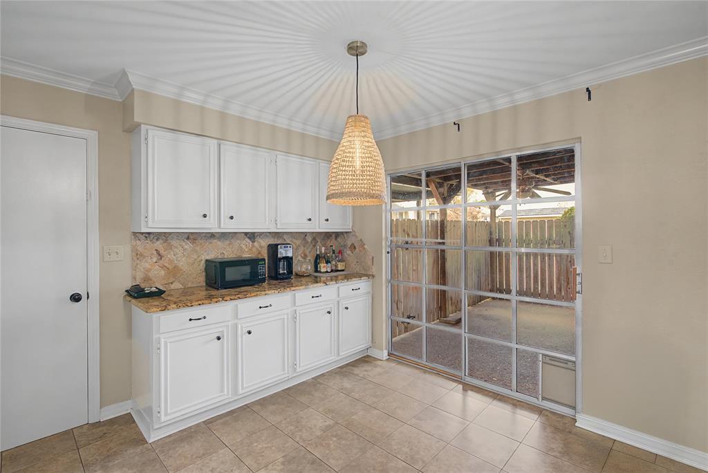 10056 Alondra Street Shreveport, LA 71115 - Photo 12 of 31 a kitchen with white cabinets and white appliances