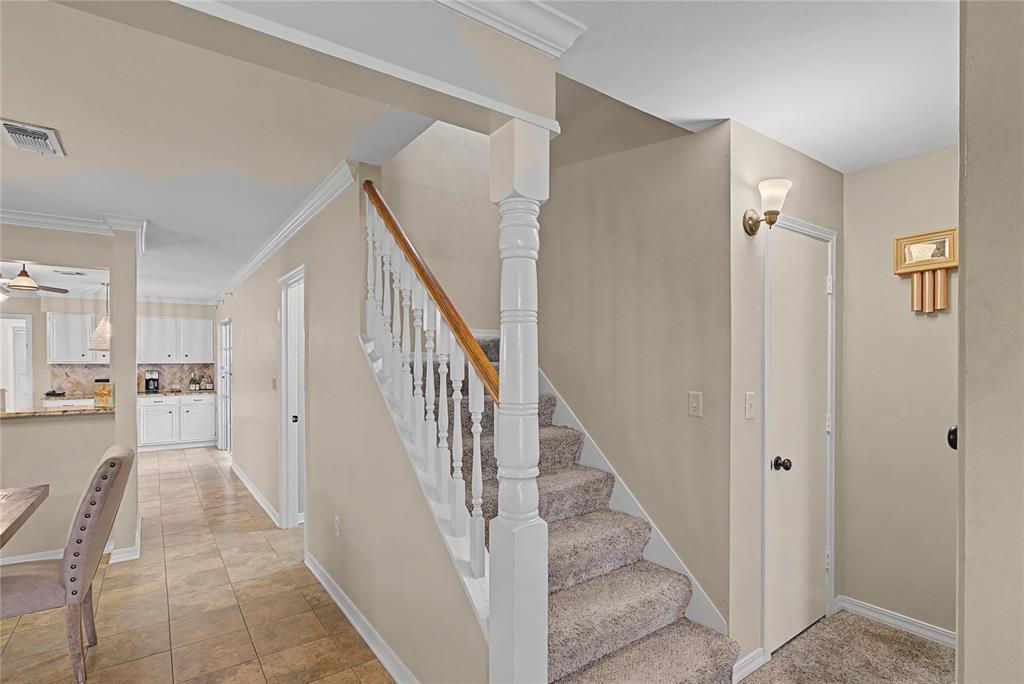 10056 Alondra Street Shreveport, LA 71115 - Photo 20 of 31 a view of a hallway with white walls and stairs