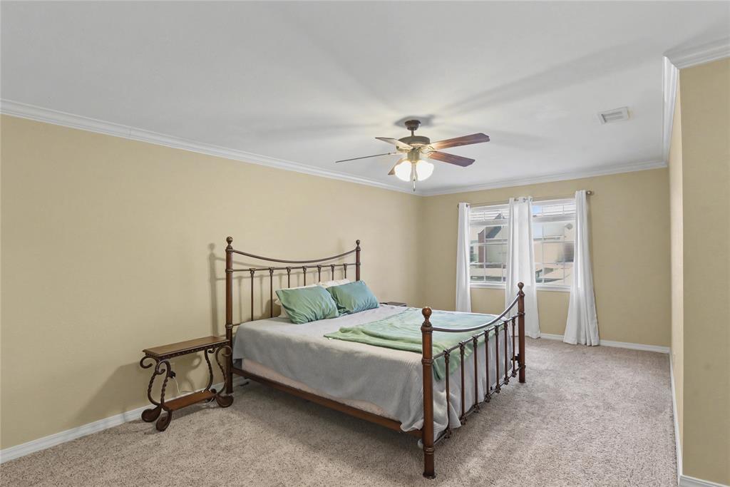 10056 Alondra Street Shreveport, LA 71115 - Photo 24 of 31 a bedroom with a bed a chandelier and closet