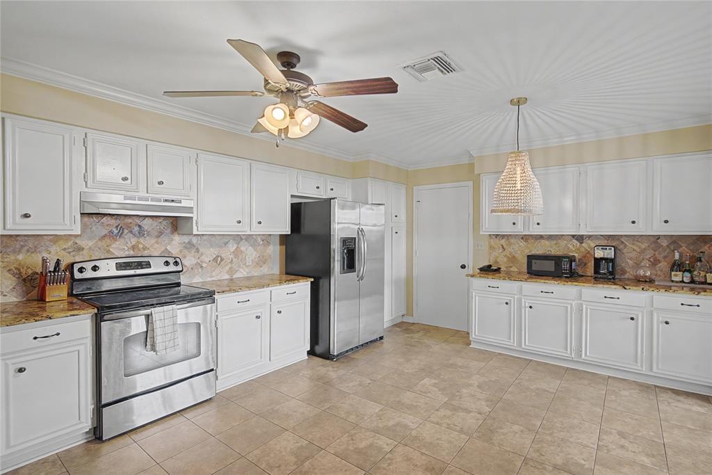10056 Alondra Street Shreveport, LA 71115 - Photo 8 of 31 a kitchen with granite countertop white cabinets white stainless steel appliances with a sink and dishwasher