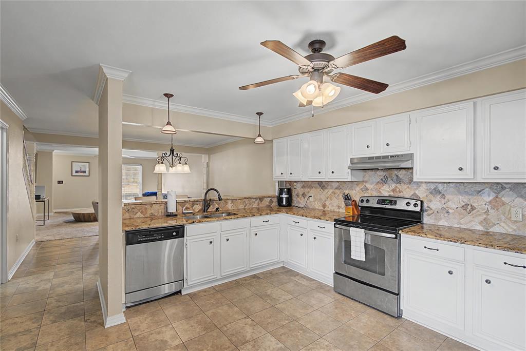10056 Alondra Street Shreveport, LA 71115 - Photo 9 of 31 a kitchen with granite countertop a sink a stove and cabinets