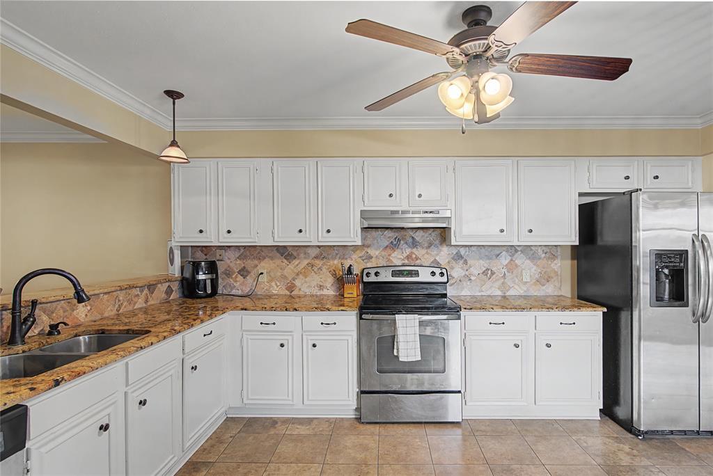 10056 Alondra Street Shreveport, LA 71115 - Photo 10 of 31 a kitchen with white cabinets stainless steel appliances and sink