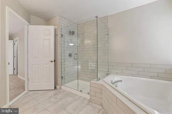 a bathroom with a bathtub and shower
