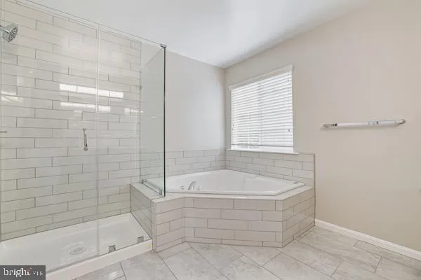 a bathroom with a bathtub and shower