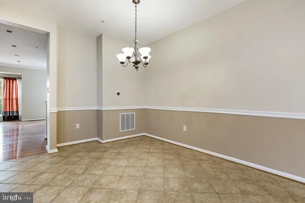 a view of an empty room with a chandelier