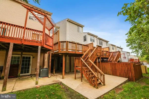 front view of a house with a small yard and a large tree