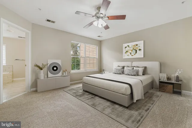 a spacious bedroom with a bed and a large window