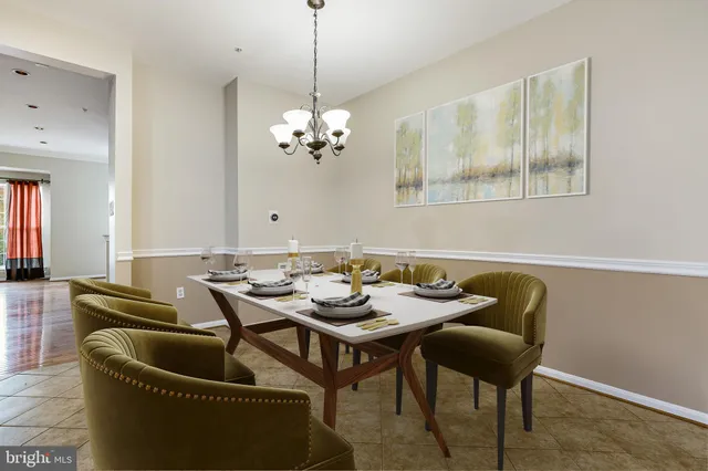 a dining room with furniture and a chandelier