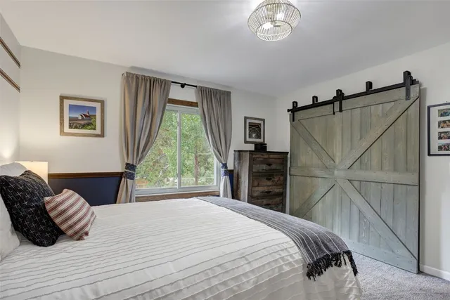 a bedroom with a bed and a chandelier