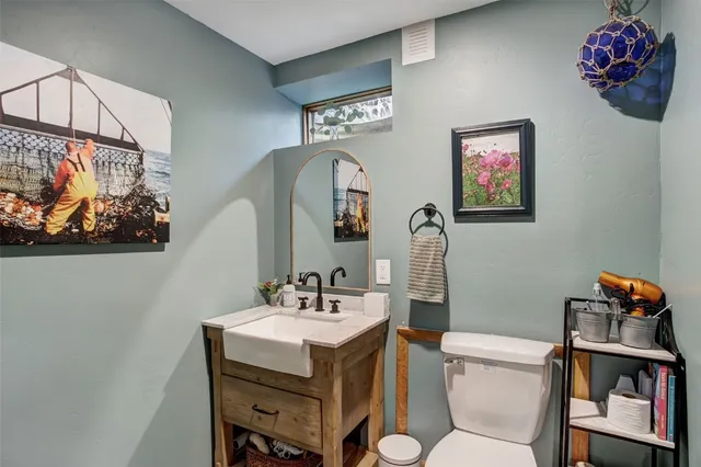 a bathroom with a sink mirror and vanity