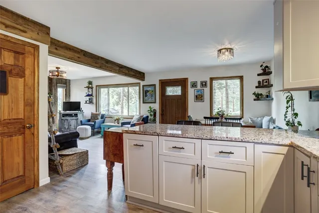 a kitchen with granite countertop a sink and a stove top oven
