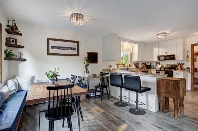 a view of a dining room with furniture window and wooden floor