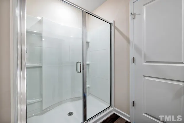 a bathroom with a glass shower door